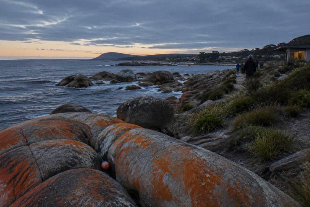 A granite coastline and dark ocean at dusk on Tasmania's east coast